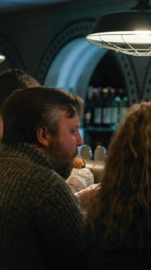 Loving Couple Having Dinner on Date in Stylish Crowded Pub