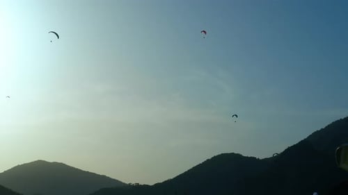 Paragliders Flying Sunset