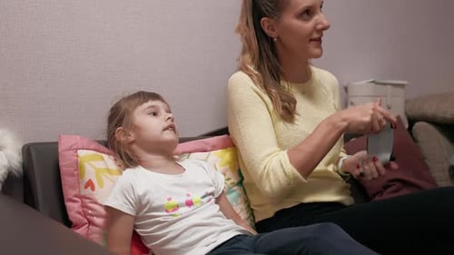 Woman and Girl Playing Video Game on Couch
