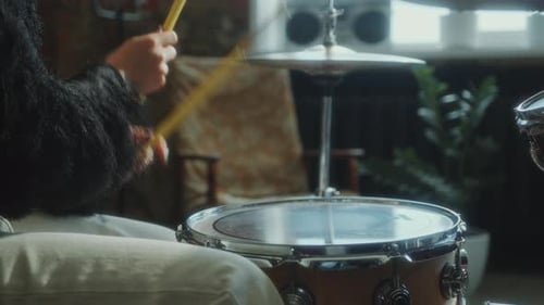 Close-Up of Female Drummer Playing Drum Kit in Studio