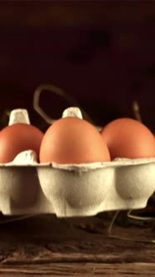 Super Slow Motion Cardboard Box with Raw Eggs Falls on the Table Filmed on a Highspeed Camera at