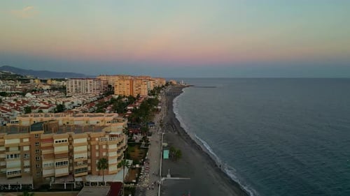 A Smooth Aerial Shot Of A Coastal City And A Mountain At A Distance In Spain