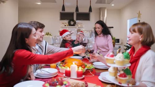 Family Celebrating Christmas Holiday with Toast and Meal