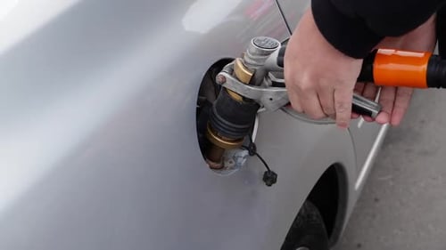 Closeup of the Hand Filling the Car with Gas