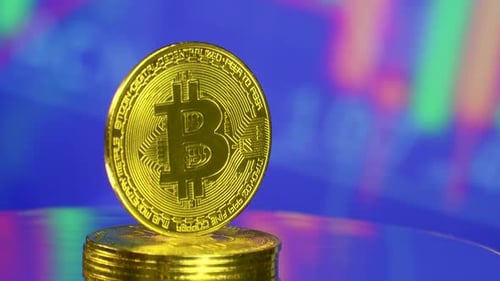 Gold Bitcoin Stack Rotating on Blue