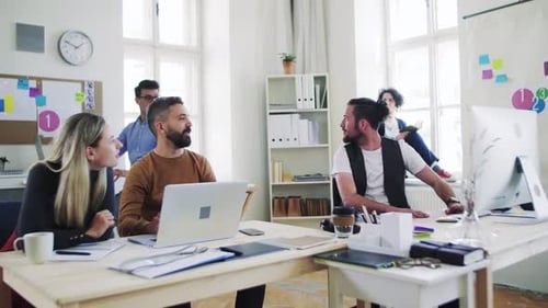 Group of Young Businesspeople Working Together in Office, Expressing Excitement