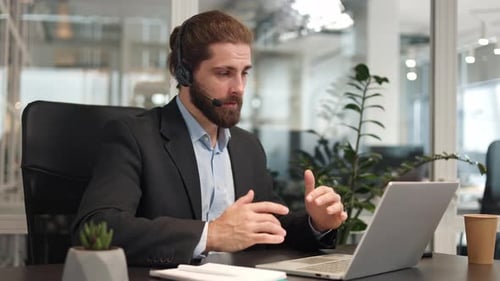 Man Talks on Headset in Modern Office