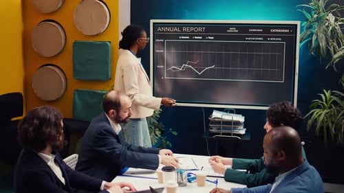 Business Team Reviewing Annual Report in Modern Office