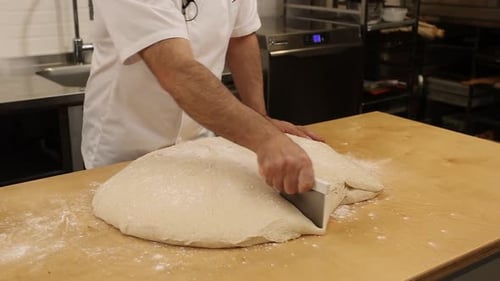 a chef makes bread in a bakery