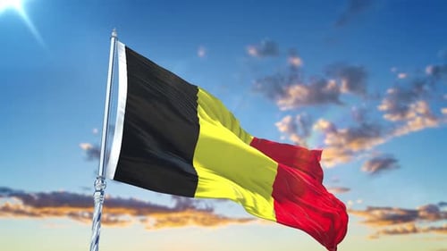 Belgian Flag Waving in Wind Against Blue Sky