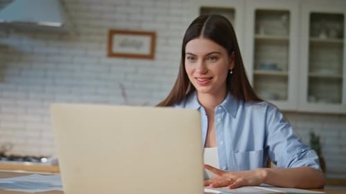 Woman Attends Video Call in Her Kitchen