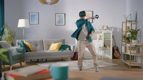 Man Using Virtual Reality Headset and Controllers at Home