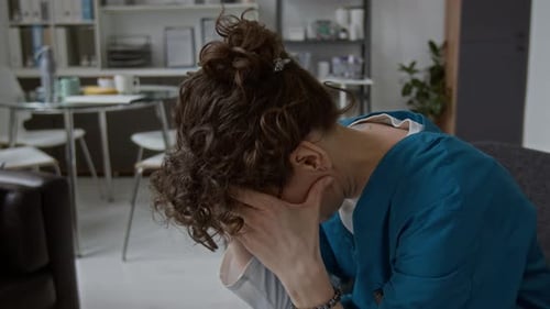 Stressed Healthcare Worker Pauses in Hospital Break Room