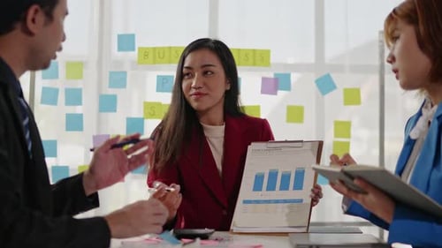 Young Adults Discuss Business in Office Setting