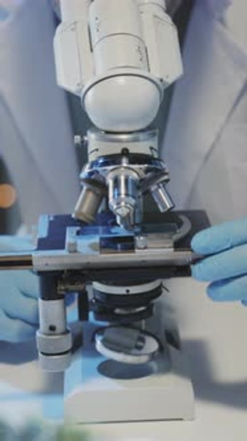 Scientist Using Microscope for Research and Discovery