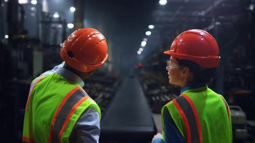 Focused Engineers Discussing Work at Huge Energy Manufacturing Tyre Factory. Male Professional