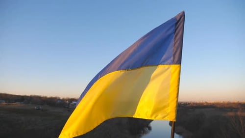 Ukrainian Flag Waving Proudly at Sunset