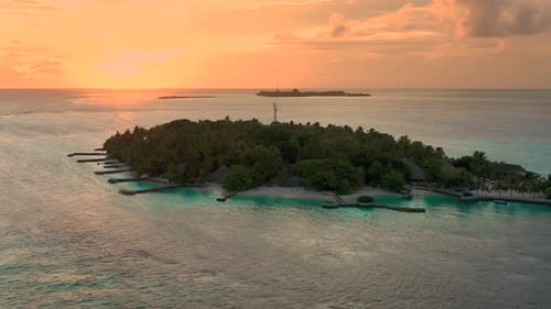Overwater Villas at the Time Amazing Sunset in Tropical Sea with Coral Reef