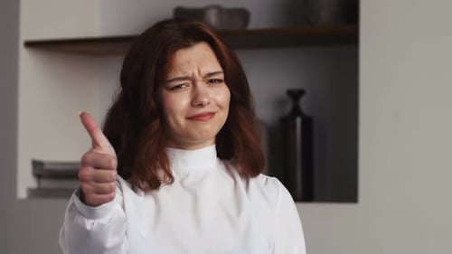 Smiling Woman Gives Thumbs Up Indoors