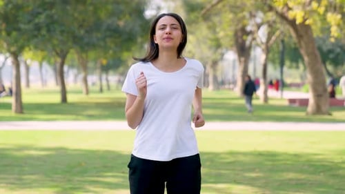 Woman Jogging in Park for Health and Fitness