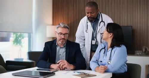 Doctors, team and talk in boardroom with documents, budget and administration at hospital