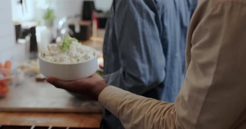 Serving a dish of white rice with vegetables