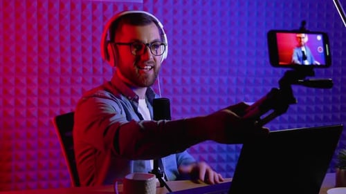 Blogger or Radio DJ Takes a Selfie During a Online Stream