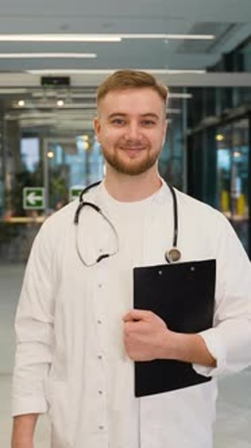 Portrait of a Young Confident Doctor Standing in a Hospital Hallway