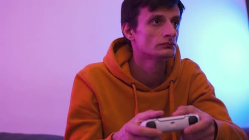 Young Adult Playing Video Game with Controller