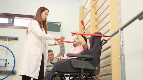 Physical Therapist Assists Patient with Resistance Band Exercises