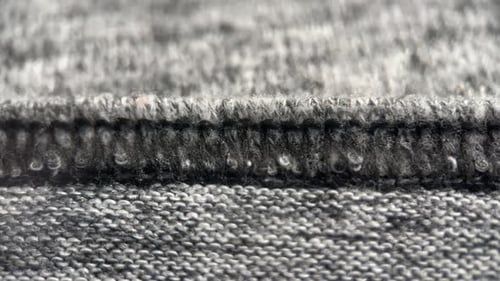 Close Up of Gray Knitted Fabric and Seam