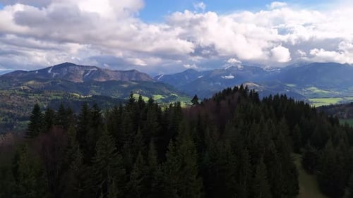 A Mountain Village in a Valley Under Mountains and Forests Bird's Eye View Over Trees Rural Mountain