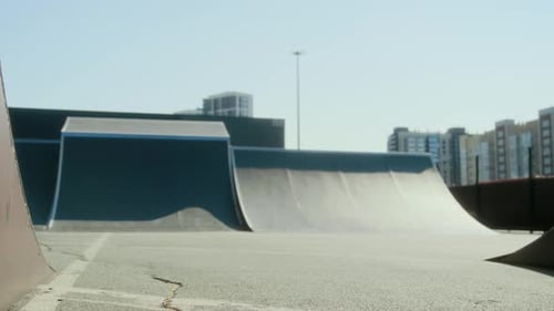 BMX Rider Lifting Front Wheel while Performing Manual Trick at Skate Park