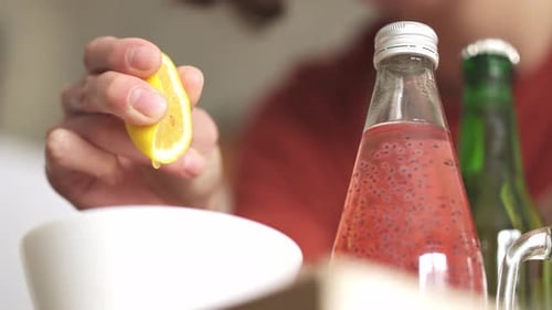 Close Up Squeezing Lemon for Refreshing Drink
