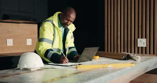 Laptop, renovation and writing with black man in kitchen for home improvement or upgrade project