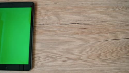 Slide Chroma Key Tablet Lying on Wooden Desk Closeup Green Screen Pad Computer