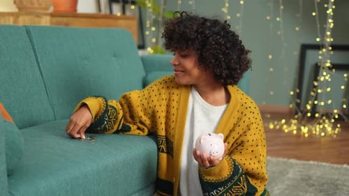 Saving Money Investment for Future African American Girl Holding Pink Piggy Bank and Putting Money