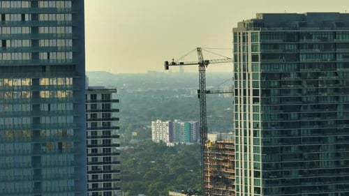 Tower Lifting Cranes at High Residential Apartment Building Construction Site Real Estate