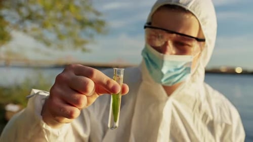 Environmental Inspector Collecting River Water Sample