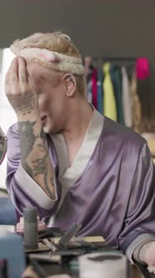 Queer Man Speaking while Applying Sculptor on Face