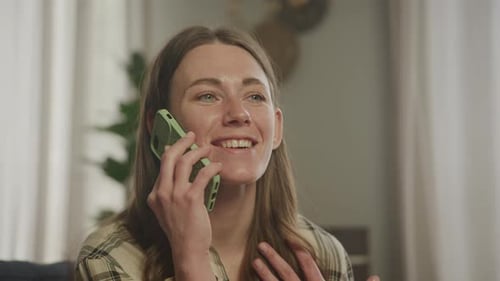 Woman Chatting on a Cell Phone Indoors