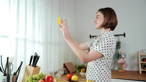 Happy mother chopping at vegetable or making salad and pose at camera. Pedagogy.