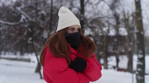 Woman Bundled Up in Snowy Winter Park