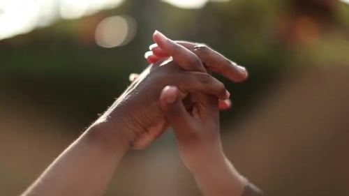 Black hands joining together in unity, two people