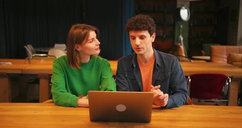 Colleagues Smiling Woman and Man Having Video Conference Meeting on Laptop in Modern Office