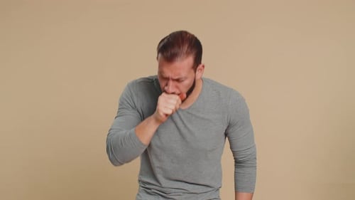 Man Coughing with a Sore Throat and Headache