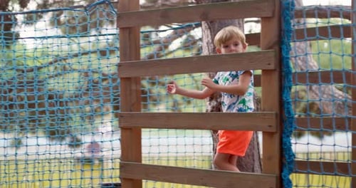 Child Navigating Obstacle Course at Adventure Park