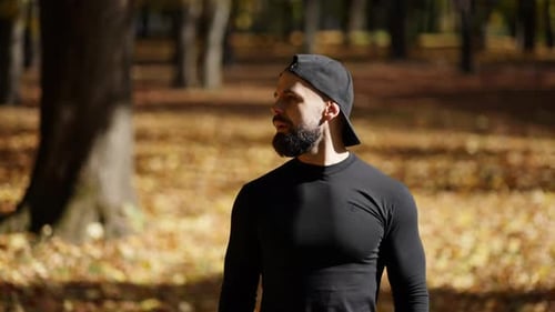 Man Stretching in Autumn Park Preparing for Workout