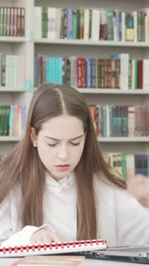 Teen Female Student Overwhelmed By Project Stress in a Library