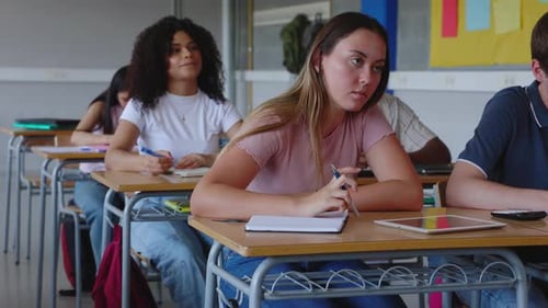 Group of Diverse Young Students Listening Teacher in Classroom at University